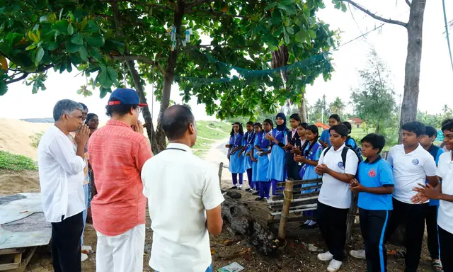 Organisers speaking with students under the trees