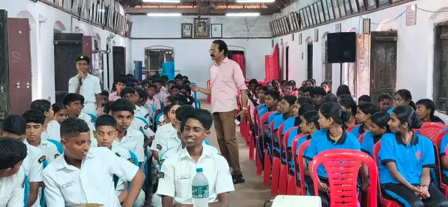Students listening to a talk in the school hall